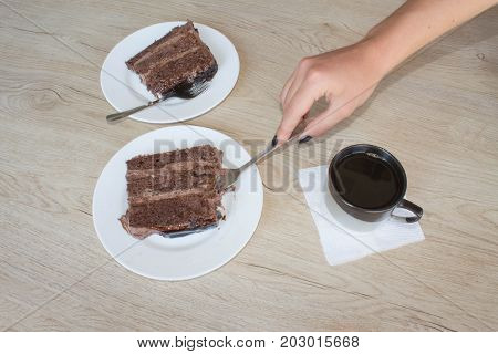Coffee cup and chocolate cake onon wooden table. Coffee and a piece of cake.