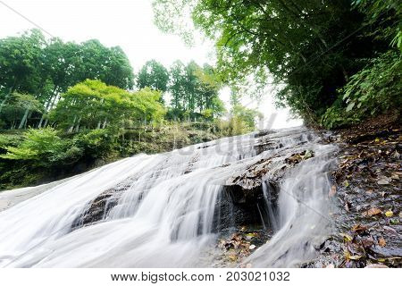 Japan travel concept - beautiful yoro keikoku valley waterfall under sun glow and morning blue sky in Chiba Prefecture Japan