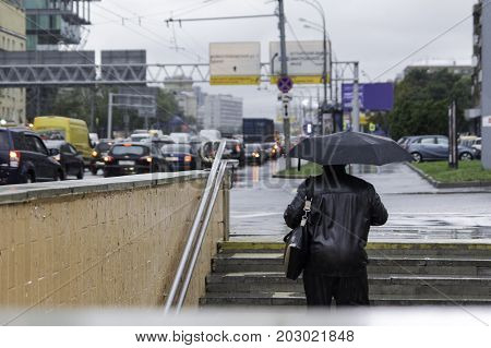 people walking with umbrellas in the rainy city. autum
