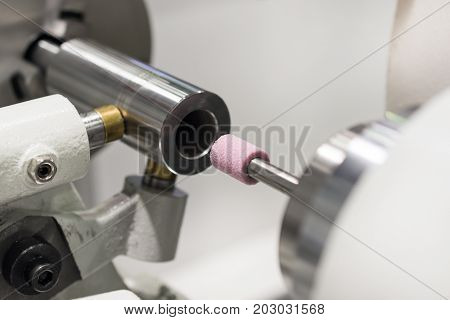 Intragrinding machine during operation. There grinding inner sleeve hole.