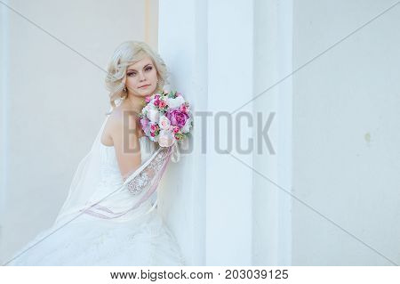 young blonde bride on a white background.