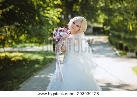 An innocent young bride boasts her veil.
