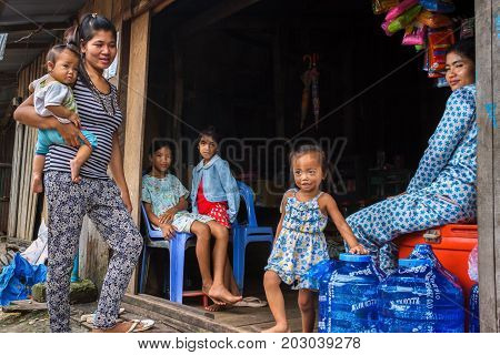 SIHANOUKVILLE CAMBODIA - 7/20/2015: A family at their local store in a rural fishing village.