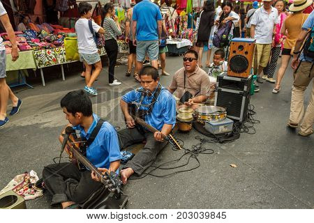 CHIANG MAI THAILAND - 6/13/2015: Musicians play for the tourists at Chiang Mai's weekly Sunday market.