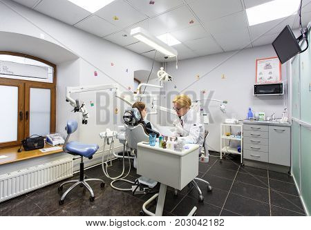 Moscow, Russia. June 2017 The dentist and the assistant work on the patient in the clinic