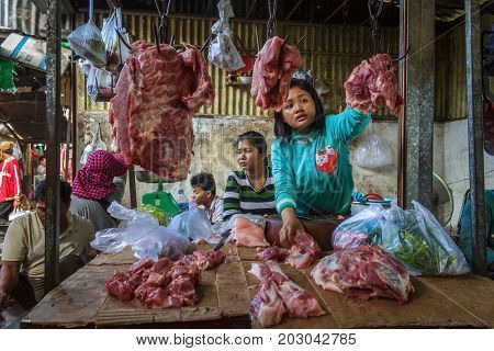 PHNOM PENH CAMBODIA - AUGUST 11 2015: A meat vendor waits for customers in the Russian market in Phnom Penh.