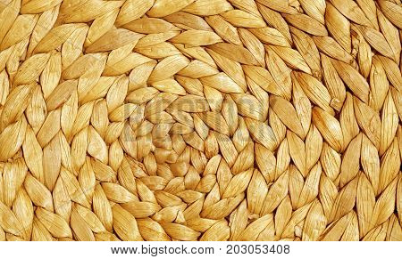 Orange Color Straw Mat Surface With Round Pattern.