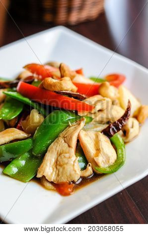 Stir-Fried Cashew Chicken, Slices of chicken breast stir-fried with cashew nuts, peapods, pineapple, onions, tomato ,and bell peppers