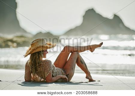 young woman relaxing on the beach in summer day