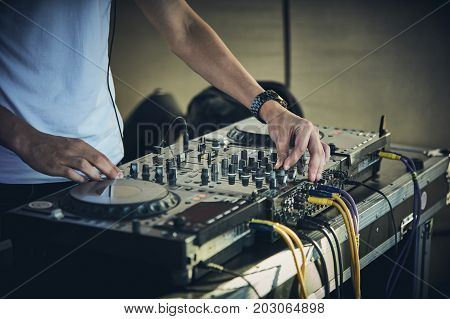 DJ's hands and turntable closeup. selective focus