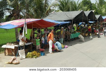 DAVAO ORIENTAL, PHILIPPINES--Famers and growers sell their produce from their makeshift tents at the street market in Banaybanay, Davao Oriental in March 2016.