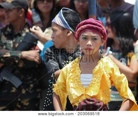 DAVAO CITY, PHILIPPINES--AUGUST 2014: A young girl in tribal costume at the Kadayawan parade.
Kadayawan is celebrated August each year to give thanks for life and an abundant harvest.
