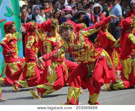 DAVAO CITY, PHILIPPINES--AUGUST 2014: Streetdancers vie for top prizes at the Kadayawan parade. Kadayawan is celebrated August each year to give thanks for life and an abundant harvest.