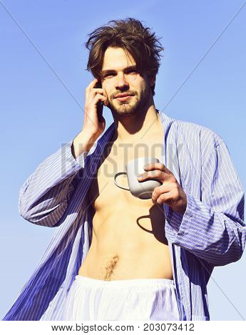Caucasian Macho In Blue Striped Pajamas Holding Cup