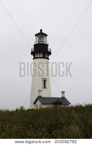 Yaquina Head Lighthouse against the cloudy Oregon sky in Newport Oregon