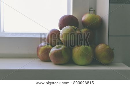 Apples on the home window with soft light and vintage filter