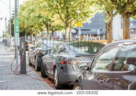 ROTTERDAM, NETHERLANDS - August 06, 2017: Tesla model S charging on the street in Rotterdam. This car is a full-sized all-electric five-door, luxury liftback, produced by Tesla, Inc