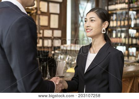 Woman With Agreement For Working With Businessman At Bar. Business Handshake And Business People Con