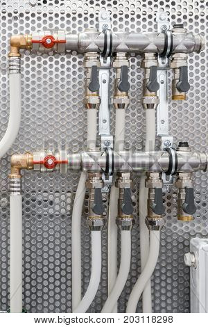 System of steel pipelines and regulators. Plactic curved tubes, brass connectors and valves.