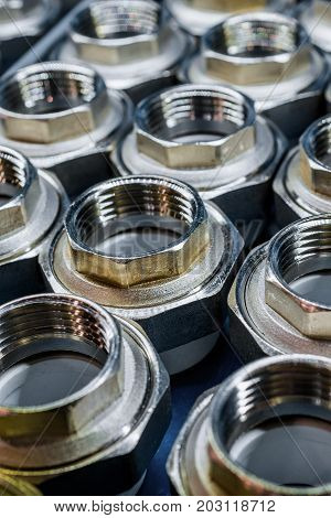 Plumbing connection fittings for plastic pipes. Orderly arranged in neat rows. Abstract industrial background.
