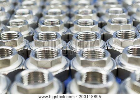 Plumbing connection fittings for plastic pipes. Orderly arranged in neat rows. Abstract industrial background.