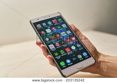 KALININGRAD, RUSSIA - CIRCA SEPTEMBER, 2017: a set of apps on Asus Zenfone 3 Ultra smartphone in woman hand.