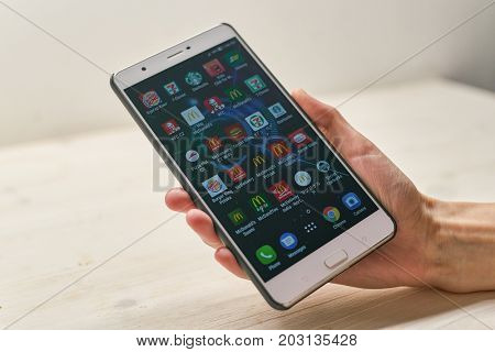 KALININGRAD, RUSSIA - CIRCA SEPTEMBER, 2017: a set of apps on Asus Zenfone 3 Ultra smartphone in woman hand.