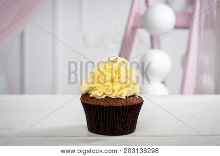 Delicious Little Cake With Yellow Icing And Candy. Horizontal Frame