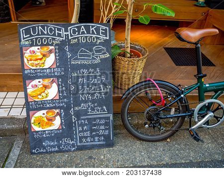 Kawagoe, Japan - May 14, 2017: Informative sign with a bike parket outside of the the testaurant, in Kawagoe, Japan.