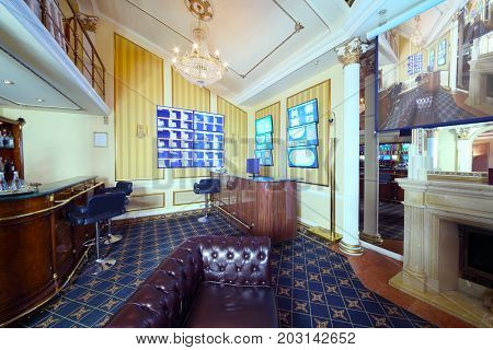 Empty bar, counter and lot of screens in luxury bookmaker office of casino