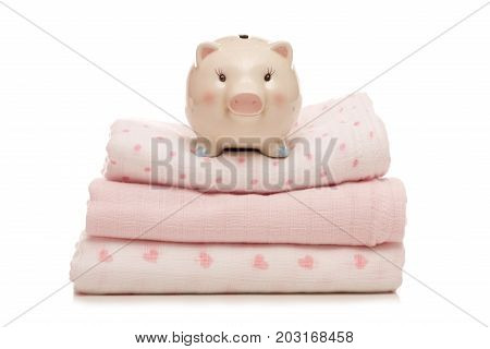 piggy bank on pink muslins on a white background cutout