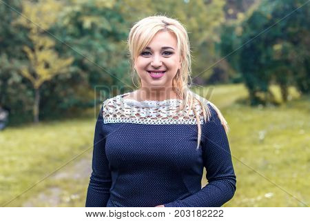 Beautiful girl model in a park, posing for photo camera