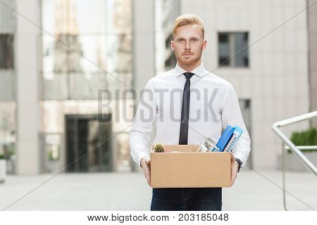 Unhappy Bearded Business Man Going Out With Cardboard, Looking At Camera And Feeling Looser.