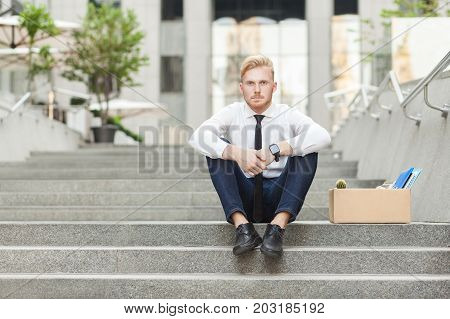Unfair Ginger Worker Sit On Stair And Seriosly Looking At Camera.