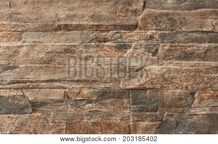 This is a floor tile with a stone wall texture in brown beige for interior and exterior Building