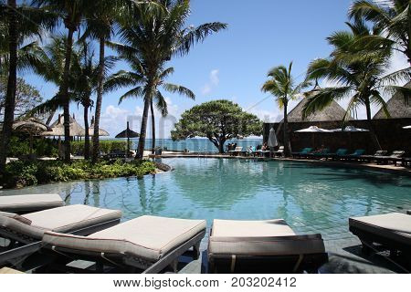 Sun beds and a pool in exotic resort