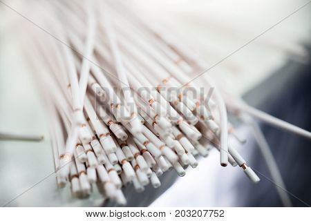 A bundle of white stripped electrical copper wires. Abstract industrial background.
