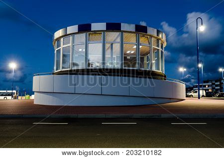 modern waiting hall in front of a street in the evening