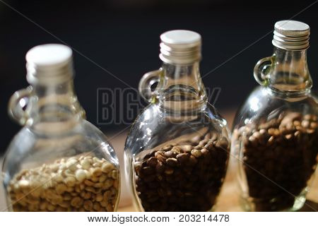 Green beans and Coffee beans inside the clear bottle Focus only subject blur backgroundChiangmai Thailand