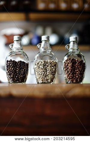 Green beans and Coffee beans inside the clear bottle Focus only subject blur backgroundCopy Space for Text Layout Chiangmai Thailand