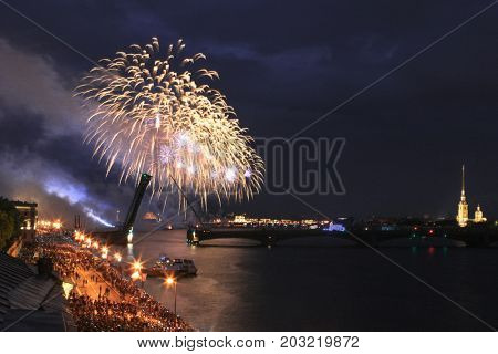 Crowd, drawbridge and fireworks at night in St. Petersburg, Russia