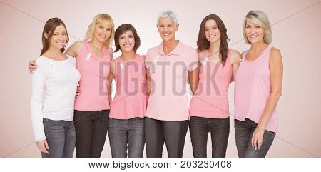 Portrait of smiling women supporting breast cancer social issue against neutral background 