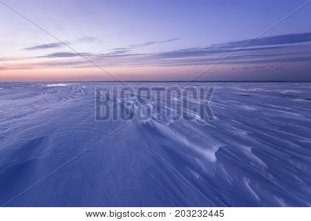 cold winter morning on the lake / the pattern of snow on the lake surface before dawn
