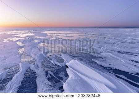 cold winter morning on the lake / the pattern of snow on the lake surface before dawn