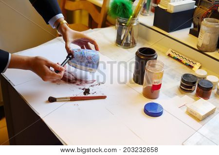 MOSCOW - SEP 22, 2016: Woman takes fingerprints from cup in Forensic Center at Petrovka, 38, Main Department of Moscow Ministry of Internal Affairs