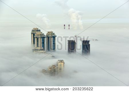 MOSCOW, RUSSIA - SEP 26, 2014: Residential complex Sparrow Hills (Vorobyovy Gory) and construction site of residential complex Dolina Setun in morning fog.