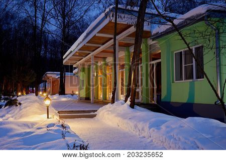 VASILYEVSKOYE, MOSCOW REGION, RUSSIA - FEB 4, 2017: One-storeyed illuminated holiday hotels on winter evening at Provence-Hotel Four Seasons. 