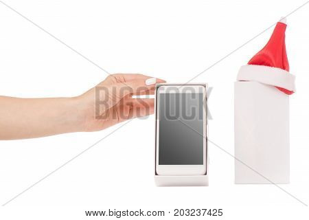 Female hand holding a mobile phone smartphone box Santa hat frost gift on a white background isilation