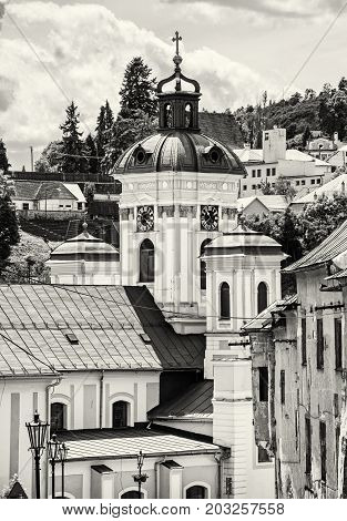 Church of the assumption Banska Stiavnica Slovak republic. Cultural heritage. Holy cross. Clock tower. Religious architecture. Black and white photo.