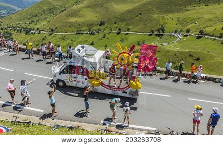Col de PeyresourdeFrance- July 23 2014: Cofidis vehicle passing in the Publicity Caravn on the road to Col de Peyresourde in Pyrenees Mountains during the stage 17 of Le Tour de France 2014.